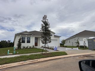 A charming white home with a spacious yard in Waterbrooke by Mattamy Homes, Clermont, FL.