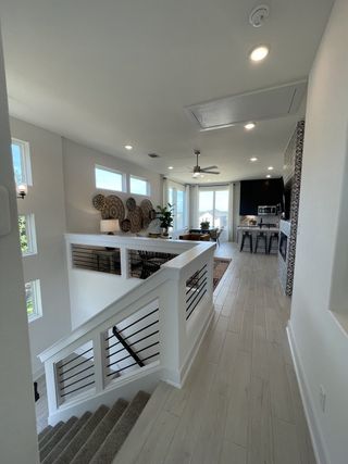 Model Home A bright, open-concept living space with modern decor, large windows, and a stylish kitchen.