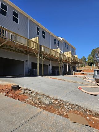 Newly constructed townhomes with wooden decks in Waypoint by D.R. Horton, Flowery Branch, GA.