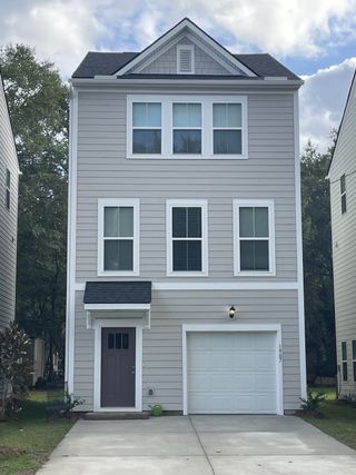 A modern three-story home with a gabled roof and fresh landscaping in Rivers Edge by DRB Homes (North Charleston, SC).