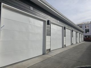 Street view A row of modern white garages in Gateway Commons by Lokal Homes, nestled in the vibrant city of Denver, CO.