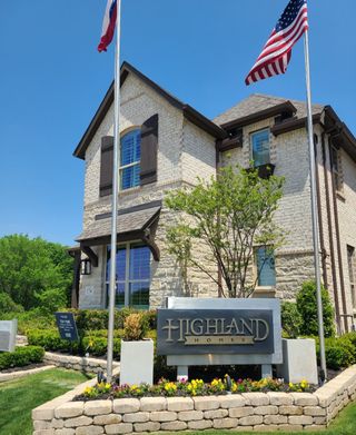 Charming stone home with rustic shutters and a landscaped yard in Aster Park: 40ft. lots by Highland Homes (McKinney, TX).