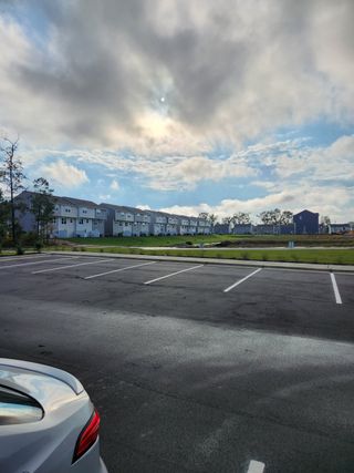 Street view Modern townhomes under a dramatic sky in Pearces Landing Single Family Homes by Ryan Homes (Zebulon, NC).