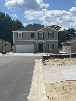 A modern two-story home with a neat driveway in Pioneer Ranch: Pioneer Ranch 40's by Lennar (Ocala, FL).