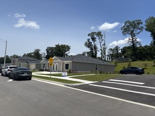 Street view Modern homes with manicured lawns in Tara Baywood by Lennar, Alachua, FL, featuring clean lines and serene surroundings.