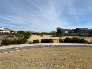 Scenic neighborhood view with spacious grounds in Bella Vista Farms: Premier by Lennar (San Tan Valley, AZ).