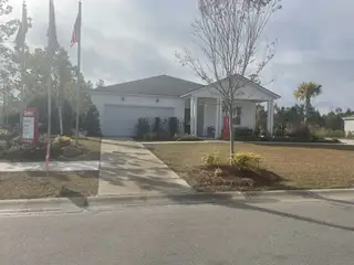 A charming single-story home with a lawn in Bradford Pointe by Centex, Summerville, SC.