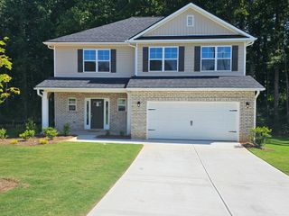 A charming two-story home with a spacious yard in Scarlett Place by Adams Homes (Bowdon, GA).