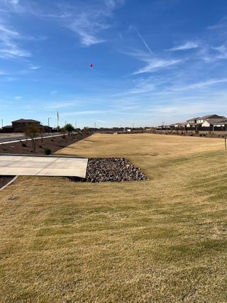 Expansive green space in El Cidro by Pulte Homes with a clear blue sky in Goodyear, AZ.