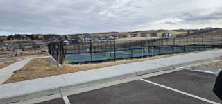 Scenic neighborhood view with tennis courts in Montaine by Brightland Homes, nestled in Castle Rock, CO.