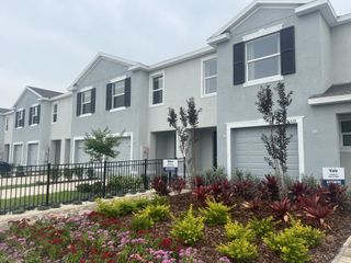Charming townhomes with modern design and lush landscaping in Towns at Woodsdale by D.R. Horton (Wesley Chapel, FL).