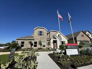 A beautiful brick home with elegant stone accents in 6 Creeks 55s by Taylor Morrison, Kyle, TX.