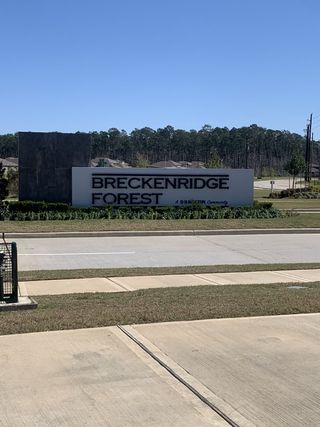 Entrance to Breckenridge Forest by D.R. Horton, showcasing a sleek sign amidst lush greenery in Spring, TX.
