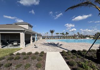 Beautiful community pool and lounge area under the expansive Florida sky in Buena Lago by D.R. Horton (St. Cloud, FL).