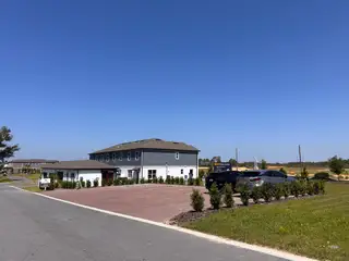 A modern sales center with sleek design and ample parking at Encore at Ovation by M/I Homes (Winter Garden, FL).