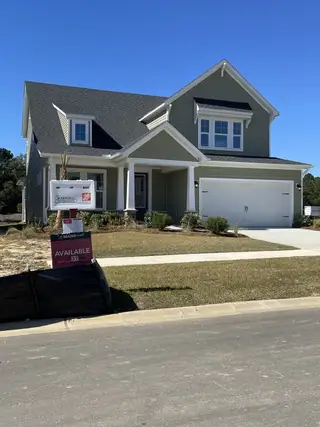 A charming green home with a spacious porch in The Groves of Berkeley by Beazer Homes (Moncks Corner, SC).