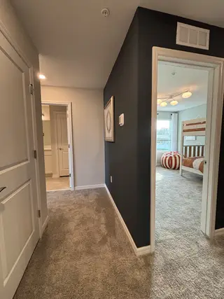 A stunning entryway with a modern staircase, high ceilings, and sleek finishes in Emerald Pointe by Pulte Homes (Apopka, FL).