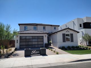 A modern home with sleek design and manicured landscaping in Emblem at Aloravita by Shea Homes (Peoria, AZ).