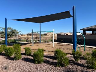 Community Amenities A modern play area with shade sails in Copper Ridge - Classic Series by Meritage Homes, Maricopa, AZ.