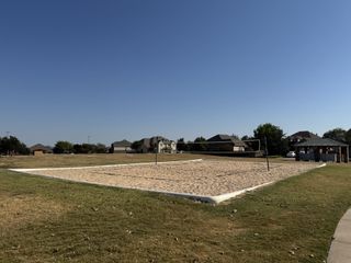A spacious sand volleyball court in a scenic neighborhood park in Blackhawk by GFO Home (Pflugerville, TX).