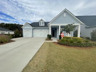 Street view A charming gray home with a spacious driveway in Horizons at Summers Corner by Lennar (Ridgeville, SC).
