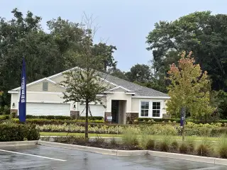 A charming beige home with a well-landscaped yard in Wynwood by D.R. Horton (Ocoee, FL).