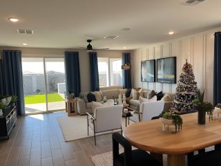 A spacious living area with large windows, elegant decor, and a festive touch, offering a cozy and stylish ambiance.