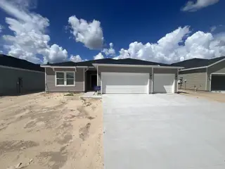 A modern home with a three-car garage and a clean facade in Pioneer Ranch: Pioneer Ranch 40's by Lennar (Ocala, FL).