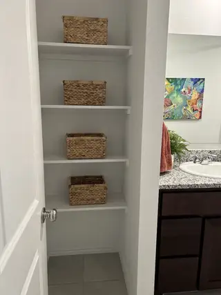 Model Home A built-in shelving unit with woven storage baskets.