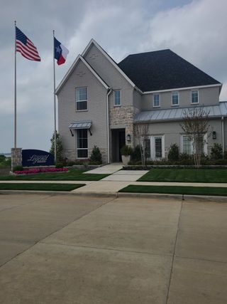 Street view Elegant brick home with manicured lawn in The Tribute - Chelsea Green by American Legend Homes (The Colony, TX).
