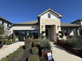 Charming stone and brick home with manicured landscaping in Turner's Crossing - Terrace Collection by Tri Pointe Homes (Austin, TX).
