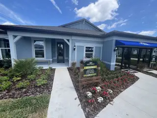 Charming blue home with lush landscaping in Marion Ranch by Pulte Homes (Ocala, FL).