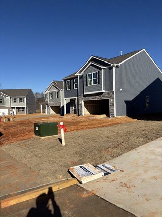 Modern gray homes with spacious yards under clear skies in Cramer Estates by D.R. Horton (Gastonia, NC).