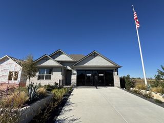 A charming single-story home with manicured landscaping in Eastern Wells by D.R. Horton (Jarrell, TX).