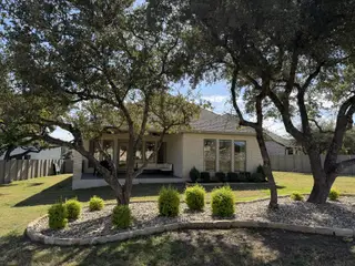 A spacious covered patio at a Perry Homes residence in Wolf Ranch, offering a cozy outdoor retreat for relaxation and entertaining.