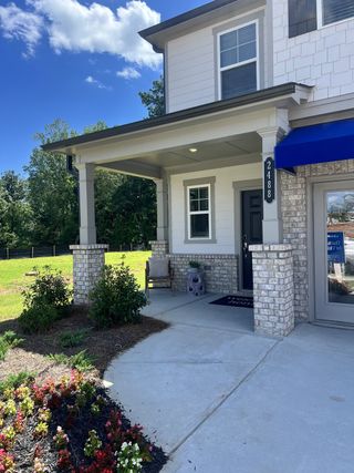 A modern two-story home with a welcoming porch and landscaped entry in Millers Pointe by Lennar (Conyers, GA).