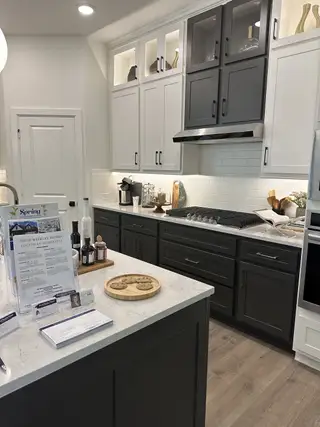 A modern kitchen featuring two-tone cabinets, sleek countertops, and a stylish island with contemporary finishes.