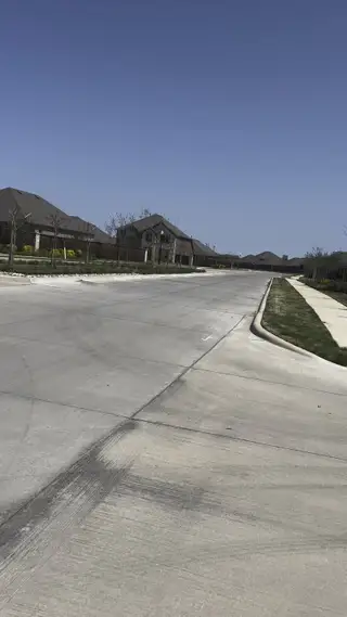 A serene community street view in Fireside by the Lake by D.R. Horton, showcasing peaceful suburban living in Garland, TX.