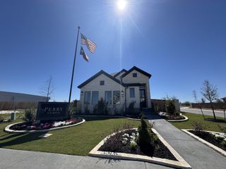 A charming light brick home with landscaped garden in The Parklands 50' by Perry Homes (Schertz, TX).