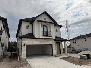 Modern two-story home with stone accents in Foxfield by Milestone Community Builders (Austin, TX).