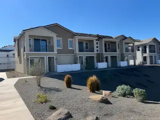 Modern townhomes with balconies and desert landscaping in Hawes Crossing: Towns by Lennar (Mesa, AZ).