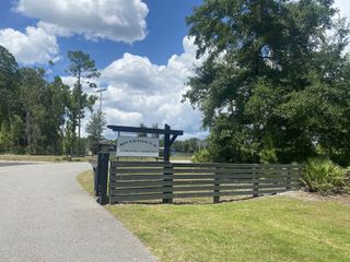 Scenic entry to RiverTown - Cove by Mattamy Homes in St. Johns, FL, with lush greenery and a welcoming path.