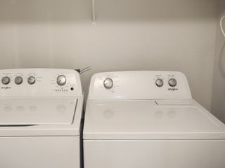 A convenient laundry room featuring a modern washer and dryer set against a neutral wall.