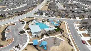 Community Amenities A stunning amenity center featuring a resort-style pool, shaded seating, and a playground.