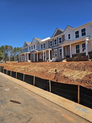 Newly constructed townhomes with striking facades in Waypoint by D.R. Horton, Flowery Branch, GA.
