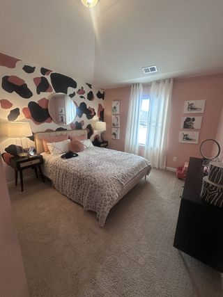 Model Home A grand bedroom with a plush bed, soft lighting, and elegant decor in Dacula, GA.