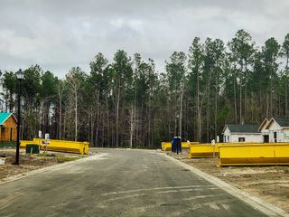 Street view A developing neighborhood with construction in progress in Kings Preserve by Breeze Homes (Jacksonville, FL).