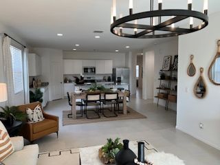 A modern open-concept living space with elegant fixtures, sleek kitchen, and cozy seating area.