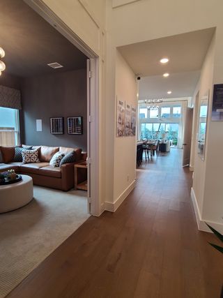 A modern interior with a cozy living area, wooden flooring, and a bright dining space.