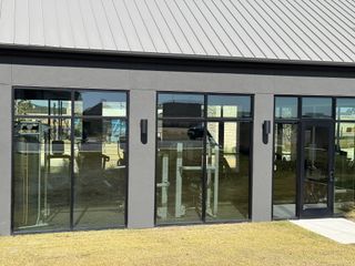 A modern fitness facility with sleek glass windows in Nolina 60' by Perry Homes (Georgetown, TX).
